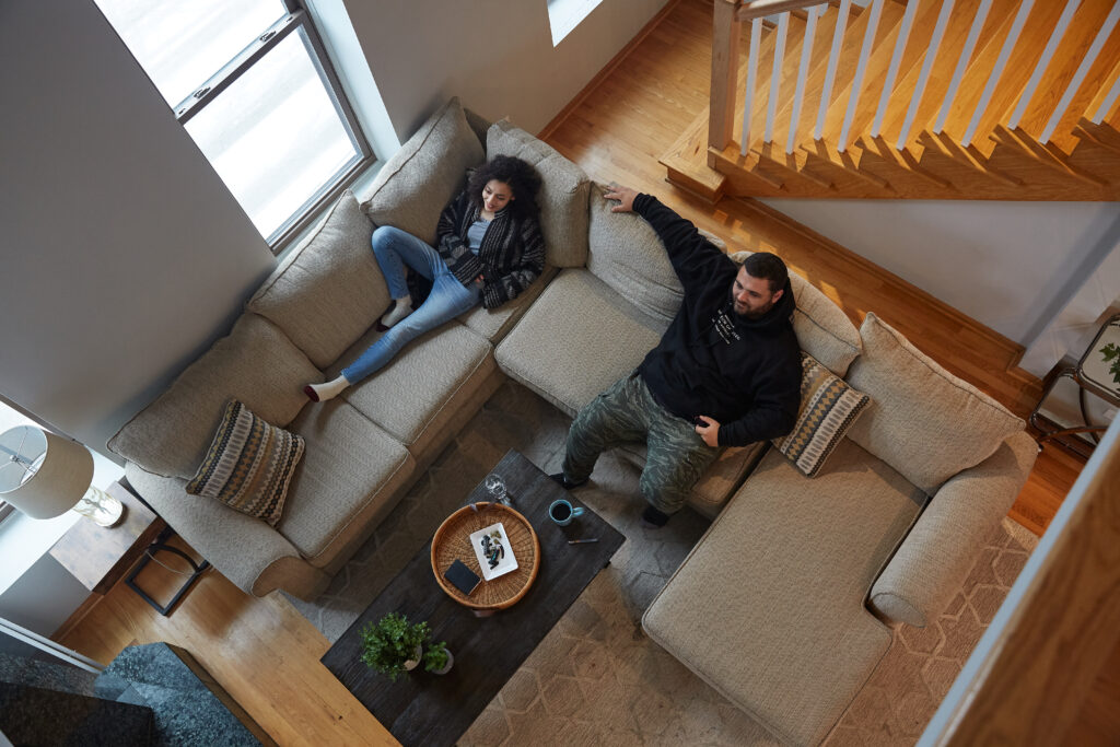 Two people on couch watching tv - image taken from overhead