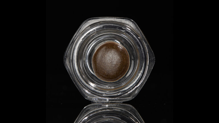 Click to see a larger version of the image Temple ball concentrate in hexagonal glass jar on black background