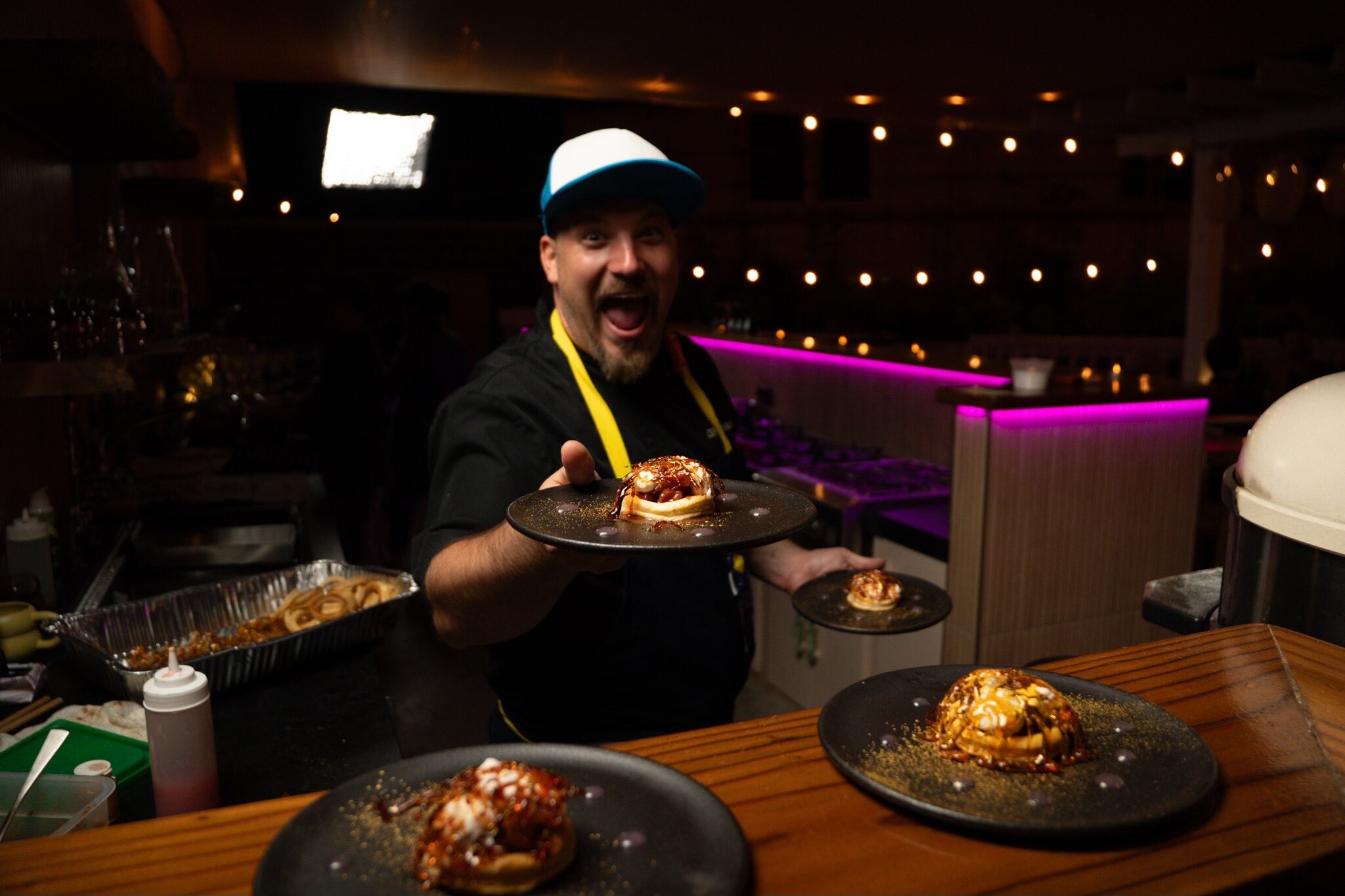 Chef Chris Binotto holding up a plate of cannabis-infused food