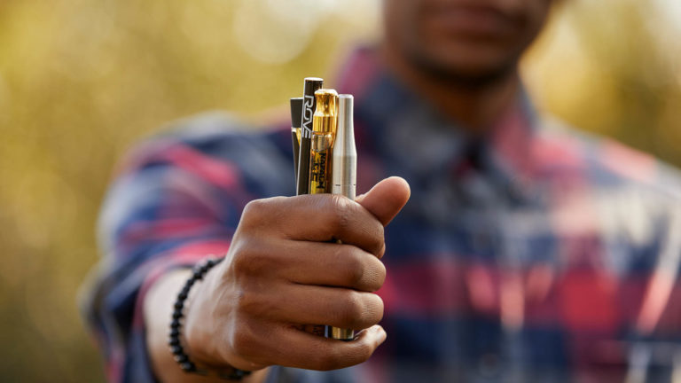 Man holding vape pens