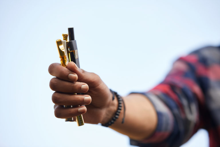 Hand holding vape pens