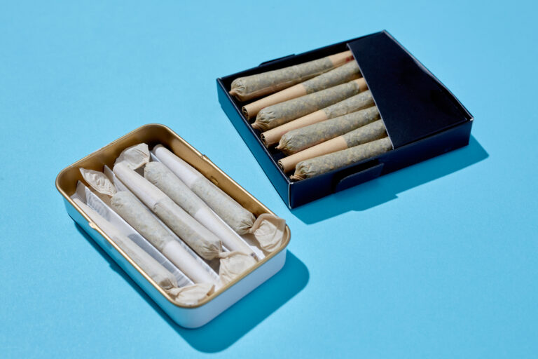 Two packs of joints on bright blue background