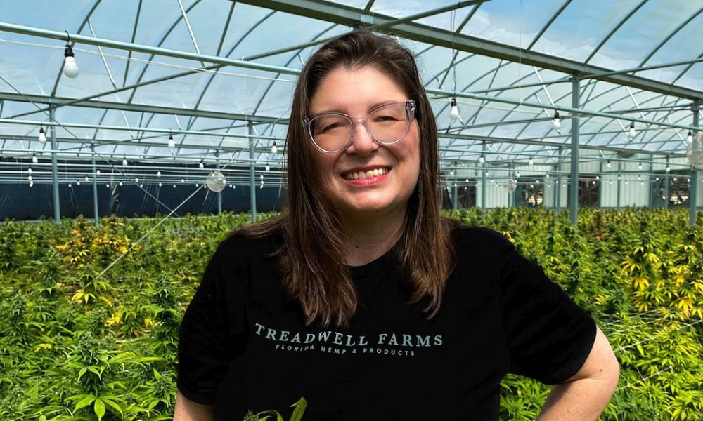 Jammie Treadwell standing inside a hemp greenhouse